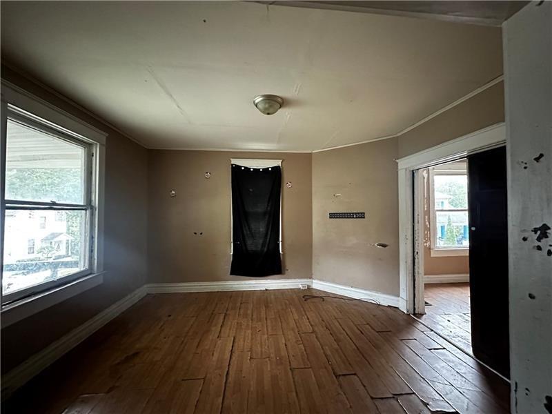 801 Butler Avenue New Castle, PA 16101 - Photo 4 of 8 an empty room with wooden floor and windows