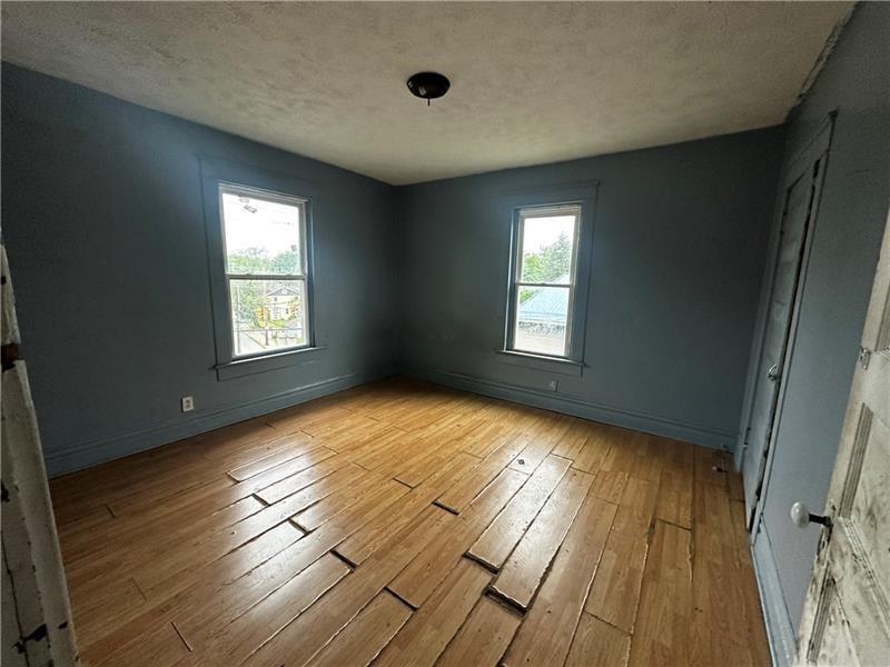 801 Butler Avenue New Castle, PA 16101 - Photo 6 of 8 a view of empty room with wooden floor and fan