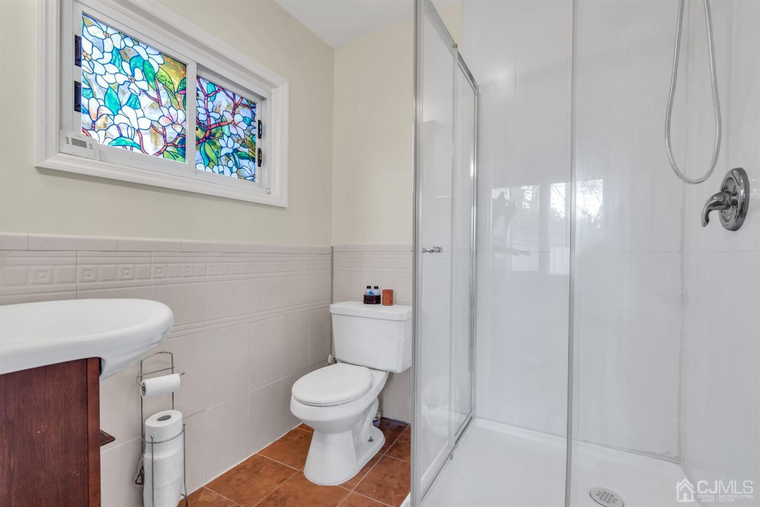 69 Stony Road Edison, NJ 08817 - Photo 18 of 33 a white toilet sitting next to a bathroom sink