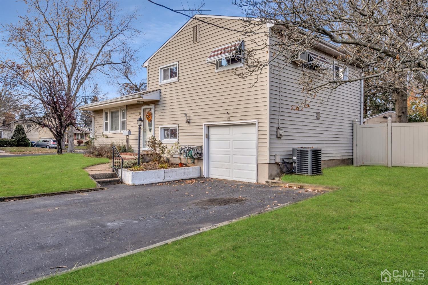69 Stony Road Edison, NJ 08817 - Photo 3 of 33 a view of a house with a yard and a patio