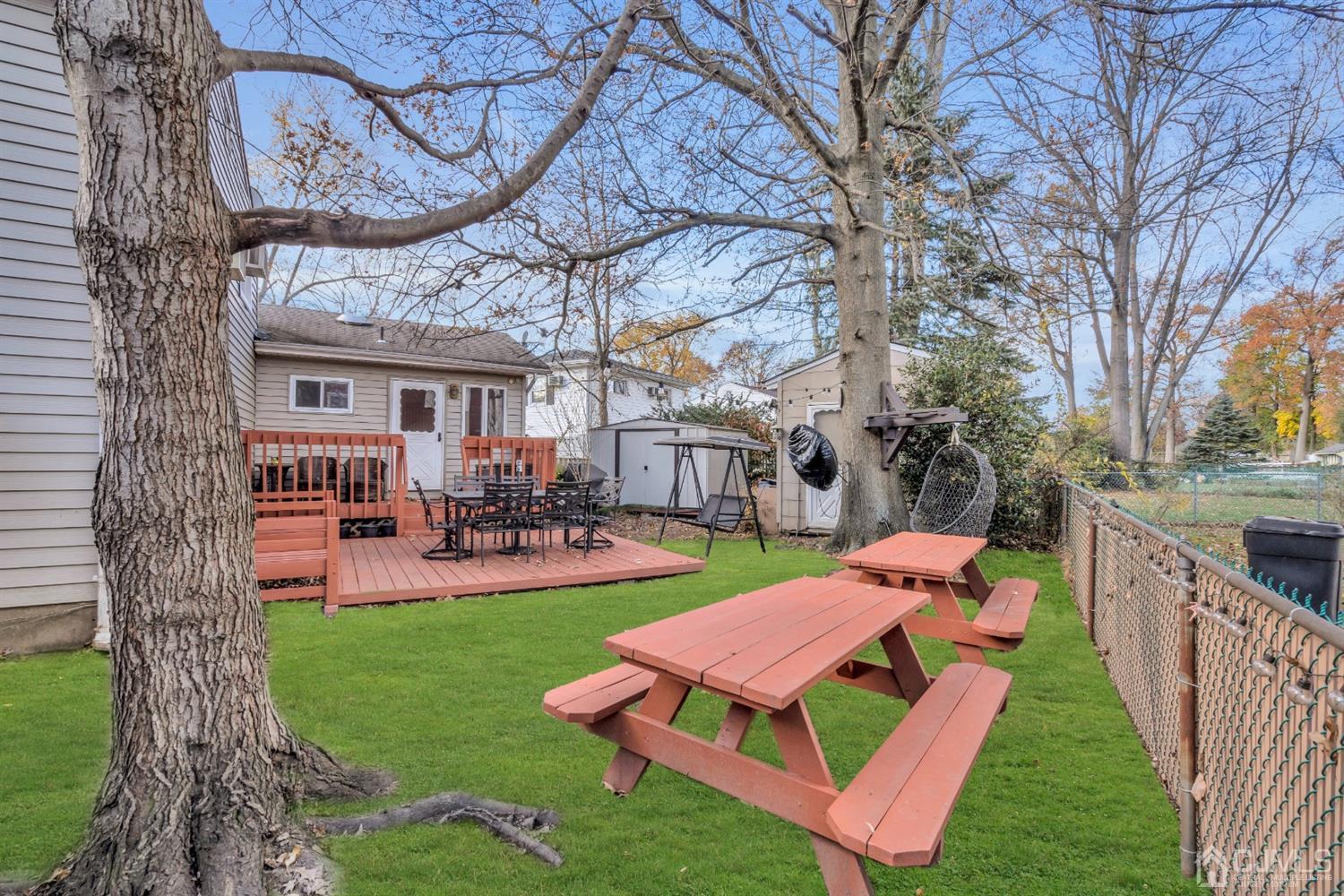 69 Stony Road Edison, NJ 08817 - Photo 29 of 33 a view of a house with a yard patio and furniture