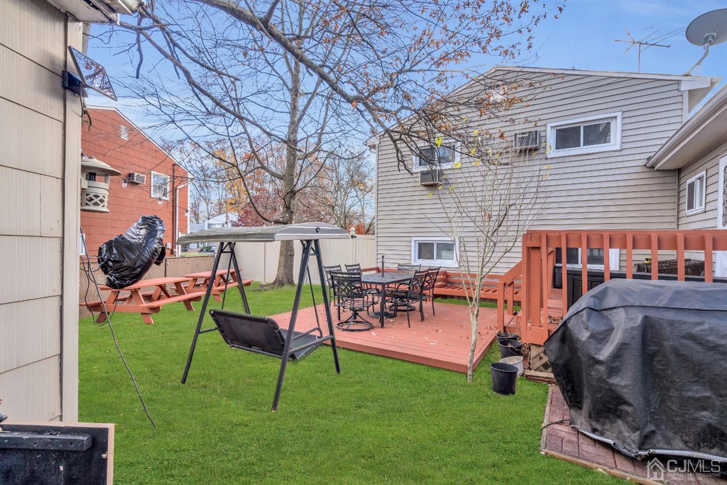 69 Stony Road Edison, NJ 08817 - Photo 31 of 33 a backyard of a house with table and chairs