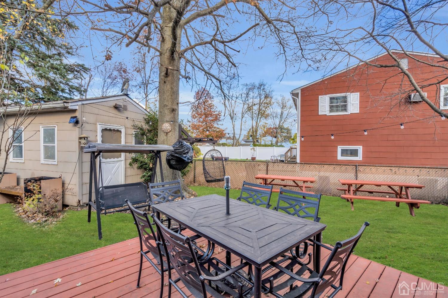 69 Stony Road Edison, NJ 08817 - Photo 32 of 33 a view of a table and chairs in backyard of the house
