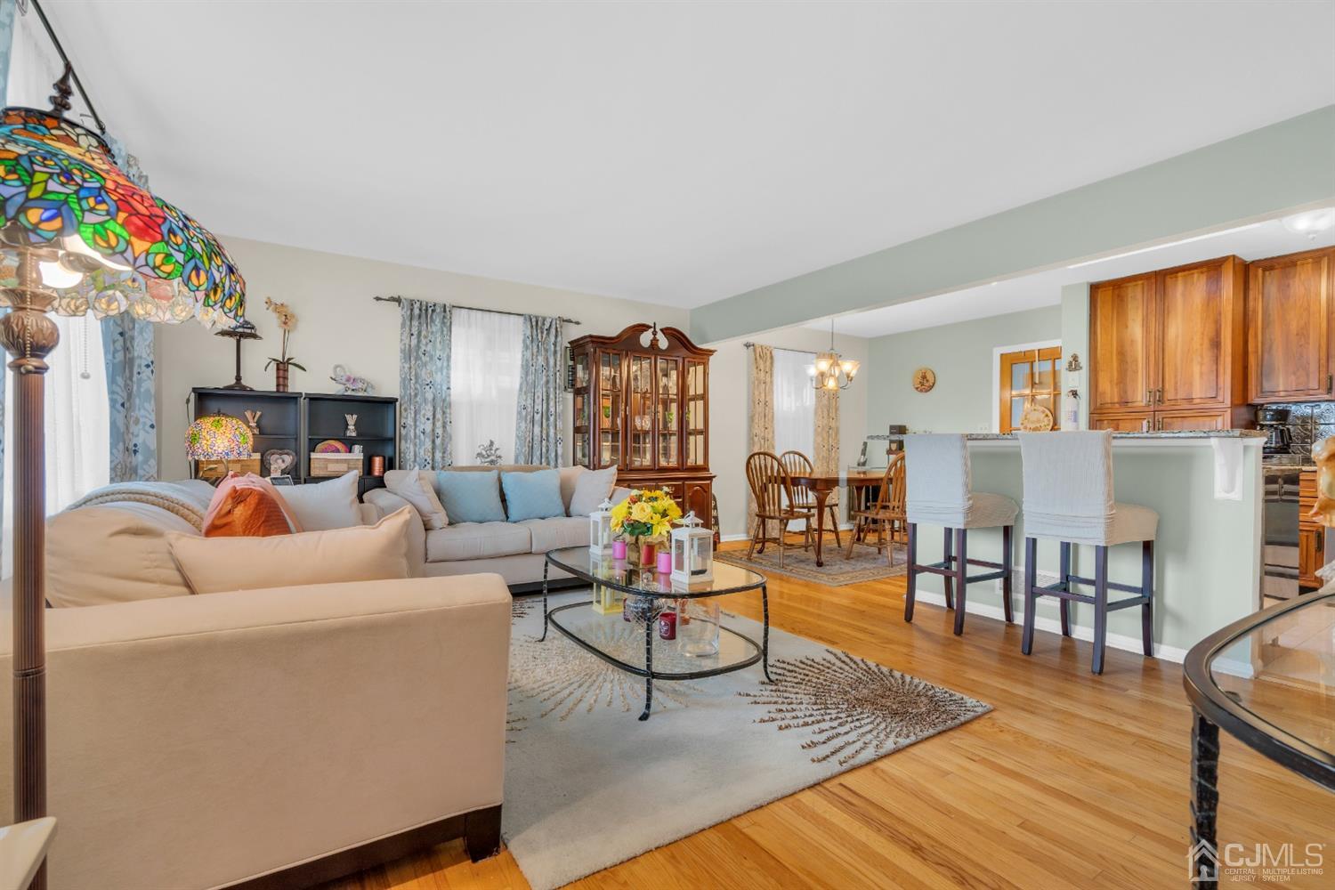69 Stony Road Edison, NJ 08817 - Photo 5 of 33 a living room with furniture a wooden floor and next to a window