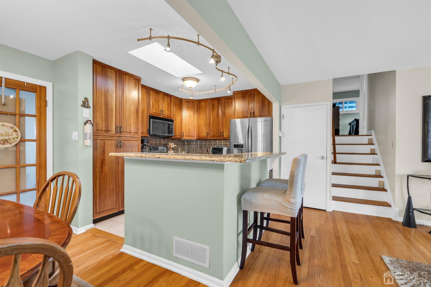 69 Stony Road Edison, NJ 08817 - Photo 9 of 33 a kitchen with cabinets and wooden floors