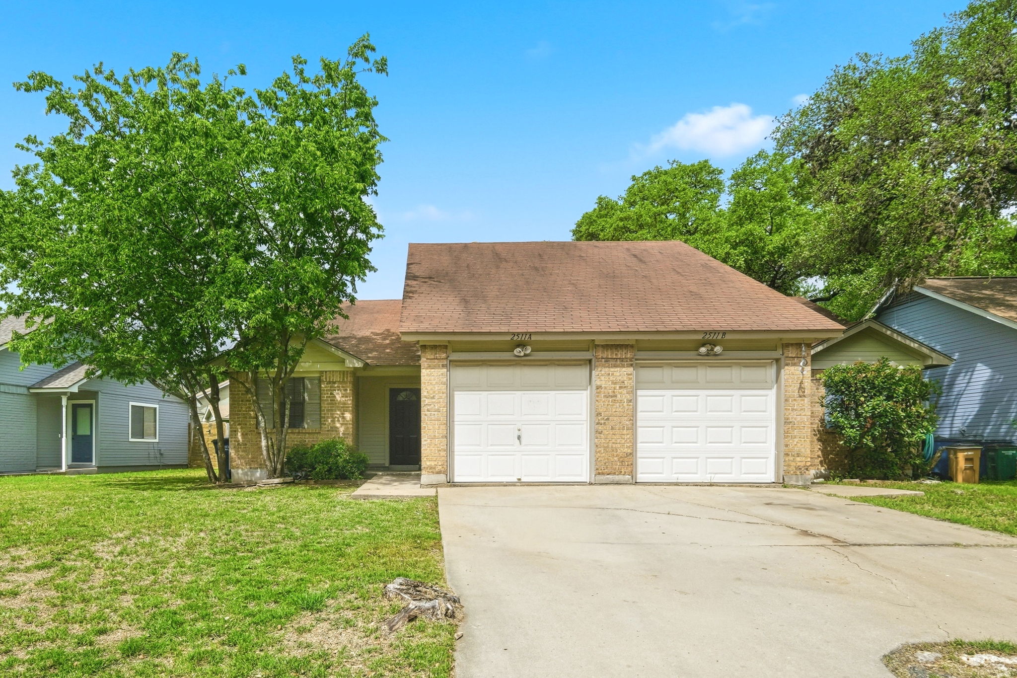 2511 Howellwood Way, Unit A Austin, TX 78748 - Photo 1 of 16 a front view of a house with a yard and garage