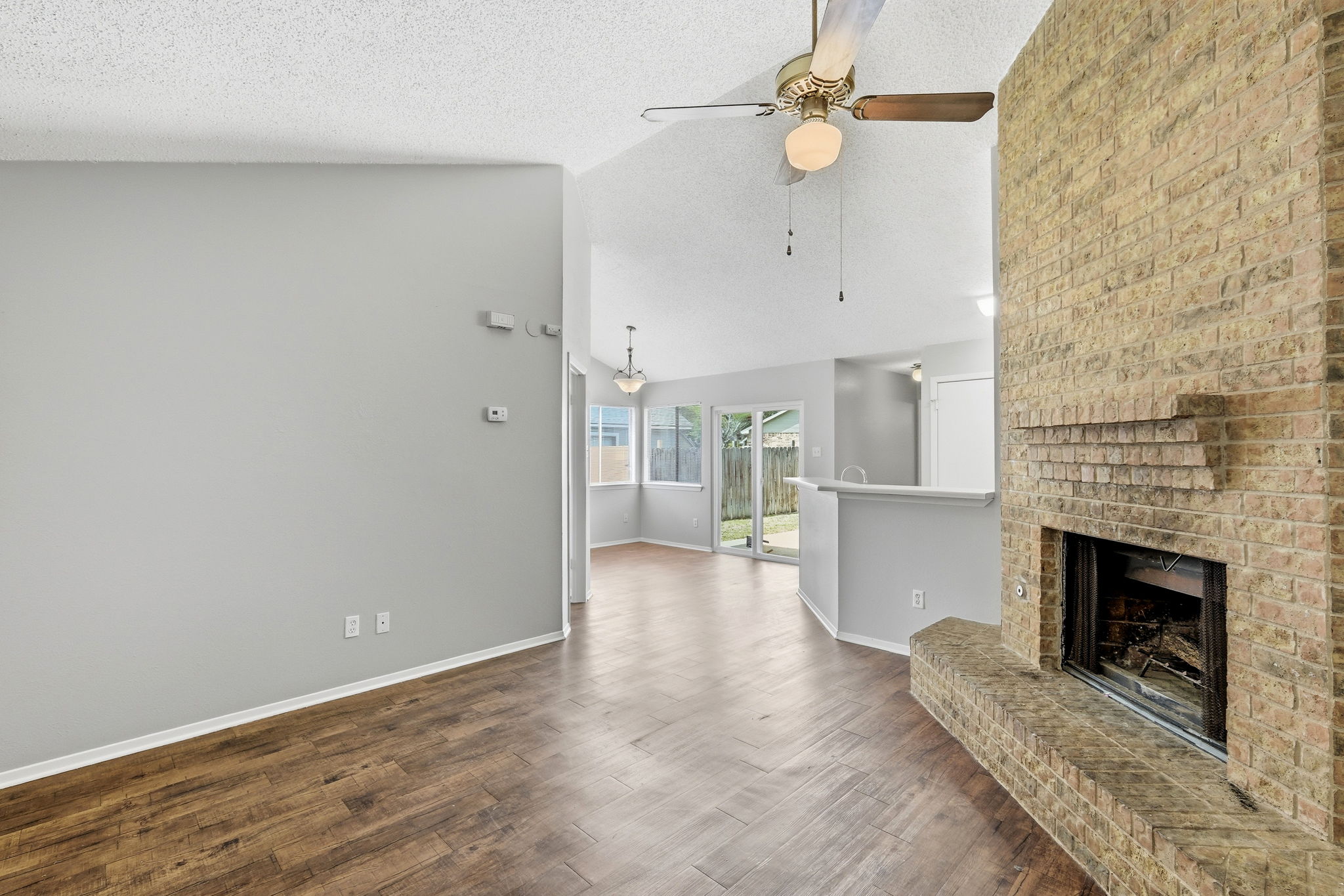 2511 Howellwood Way, Unit A Austin, TX 78748 - Photo 4 of 16 an empty room with windows and fireplace