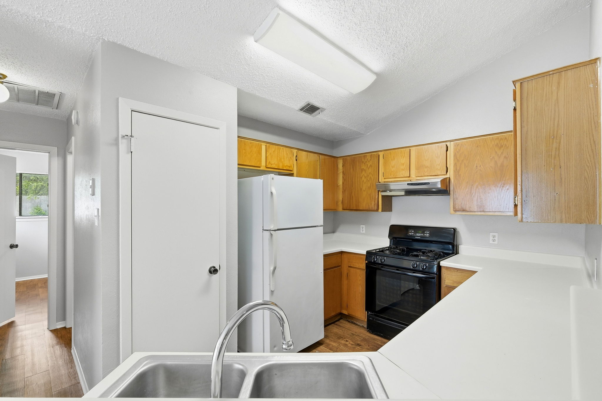 2511 Howellwood Way, Unit A Austin, TX 78748 - Photo 6 of 16 a kitchen with stainless steel appliances a refrigerator a sink a stove top oven a counter space and cabinets