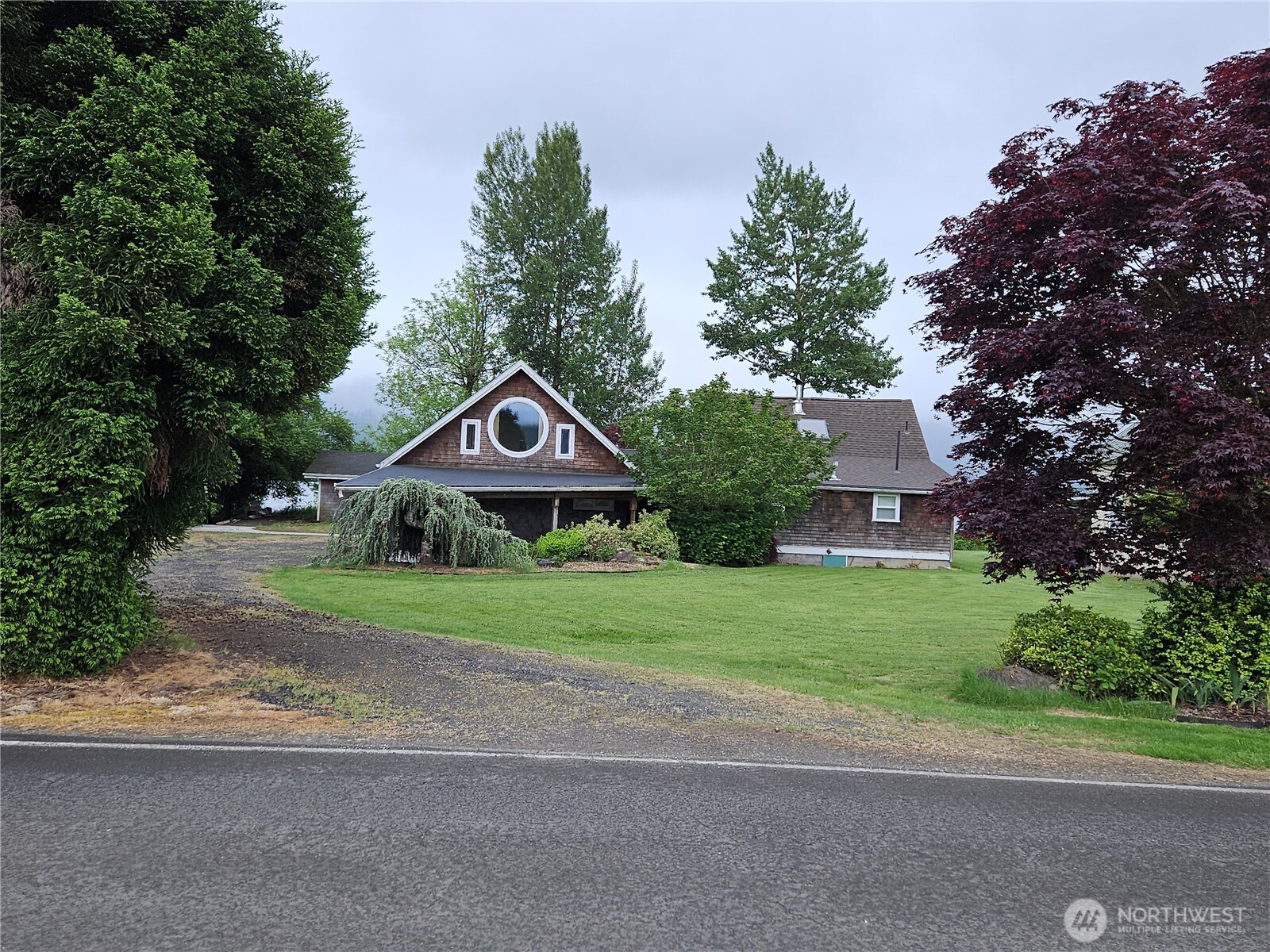 20 East Sunny Sands Road Cathlamet, WA 98612 - Photo 1 of 19 a front view of a house with a yard and garage