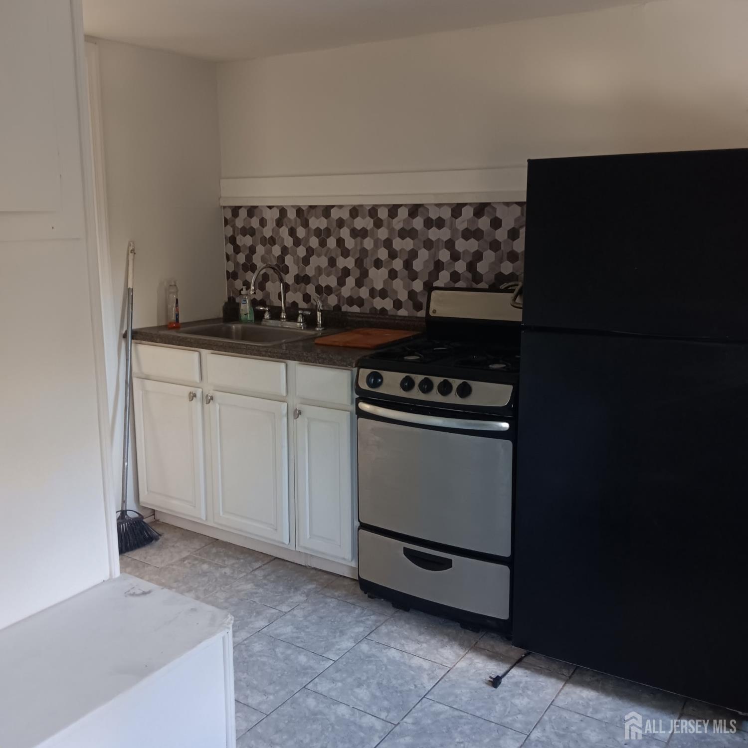 a kitchen with a sink and a stove