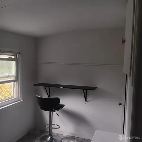 a view of room with window and furniture