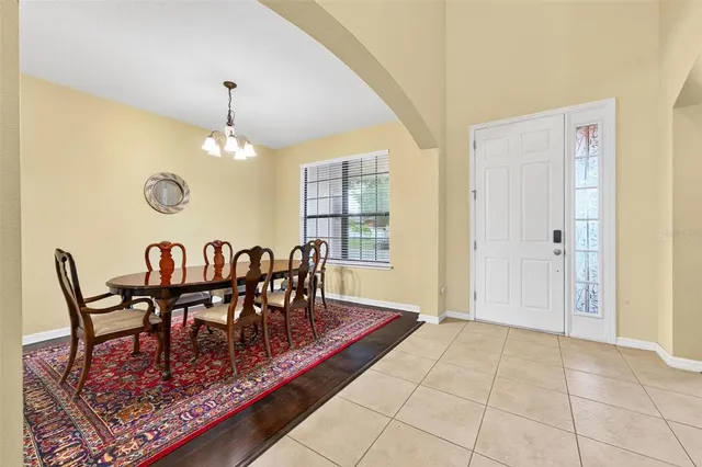a view of a dining room with furniture and chandelier