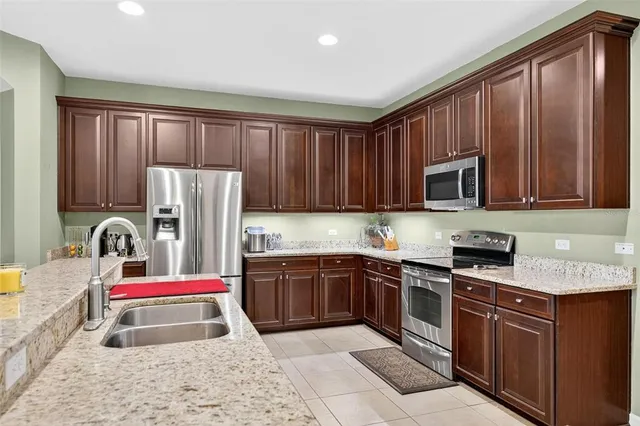 a bathroom with a granite countertop sink a large mirror and a window
