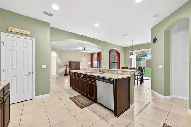 a view of a kitchen with stainless steel appliances granite countertop a refrigerator and a sink