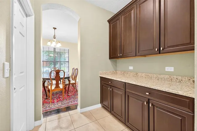 a view of a dining room with furniture and a kitchen