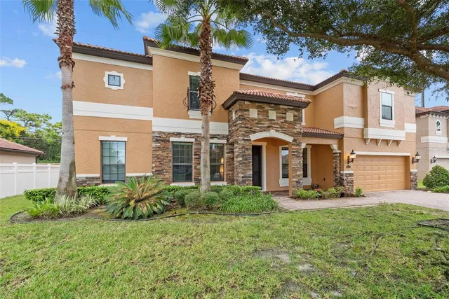 a front view of a house with lots of green space