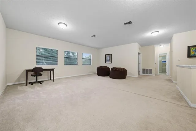 a bedroom with two beds and painted window