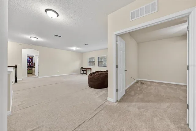 a spacious bathroom with a sink and a mirror