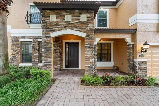 a view of a hallway with chairs and couches with wooden floor