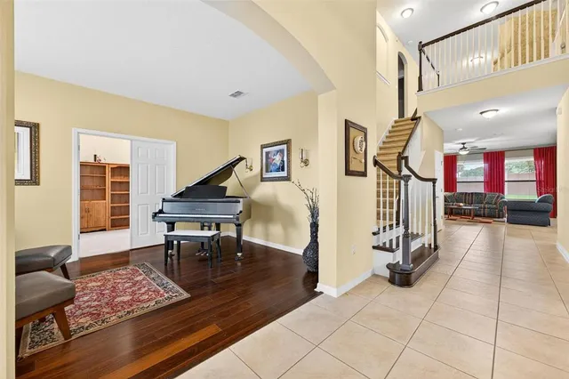 a living room with furniture and a wooden floor