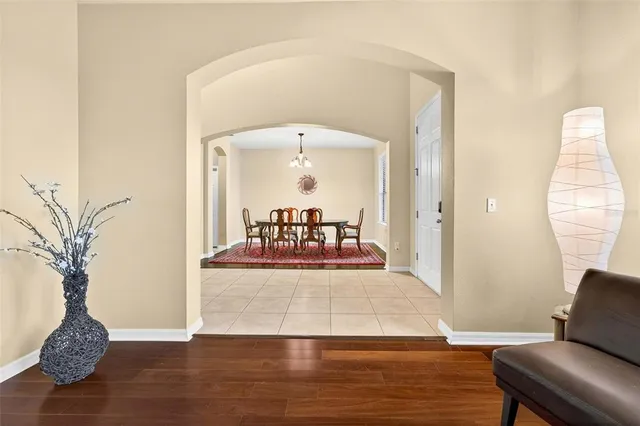 a view of a dining room and livingroom with furniture wooden floor and a rug