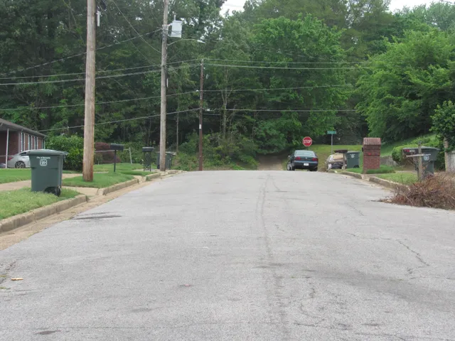 a view of a house with a bench in a yard