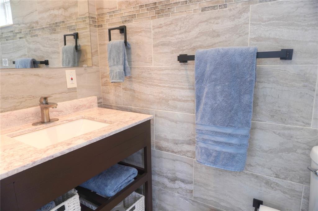 104 163rd Avenue Redington Beach, FL 33708 - Photo 12 of 22 a bathroom with a sink and a mirror