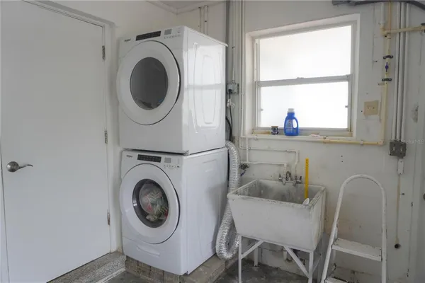 a utility room with sink dryer and washer