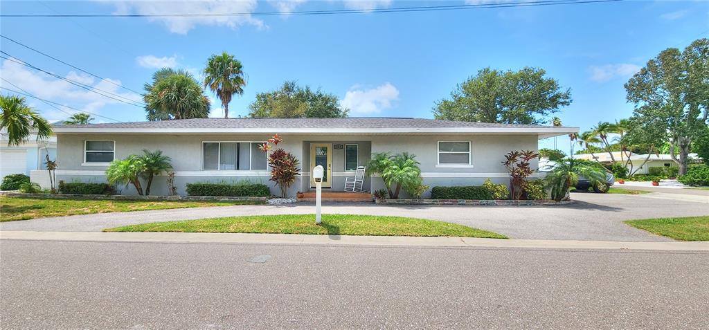 104 163rd Avenue Redington Beach, FL 33708 - Photo 3 of 22 a front view of house with garage and green space