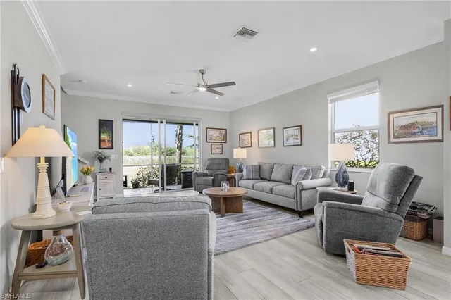 a living room with furniture and a chandelier