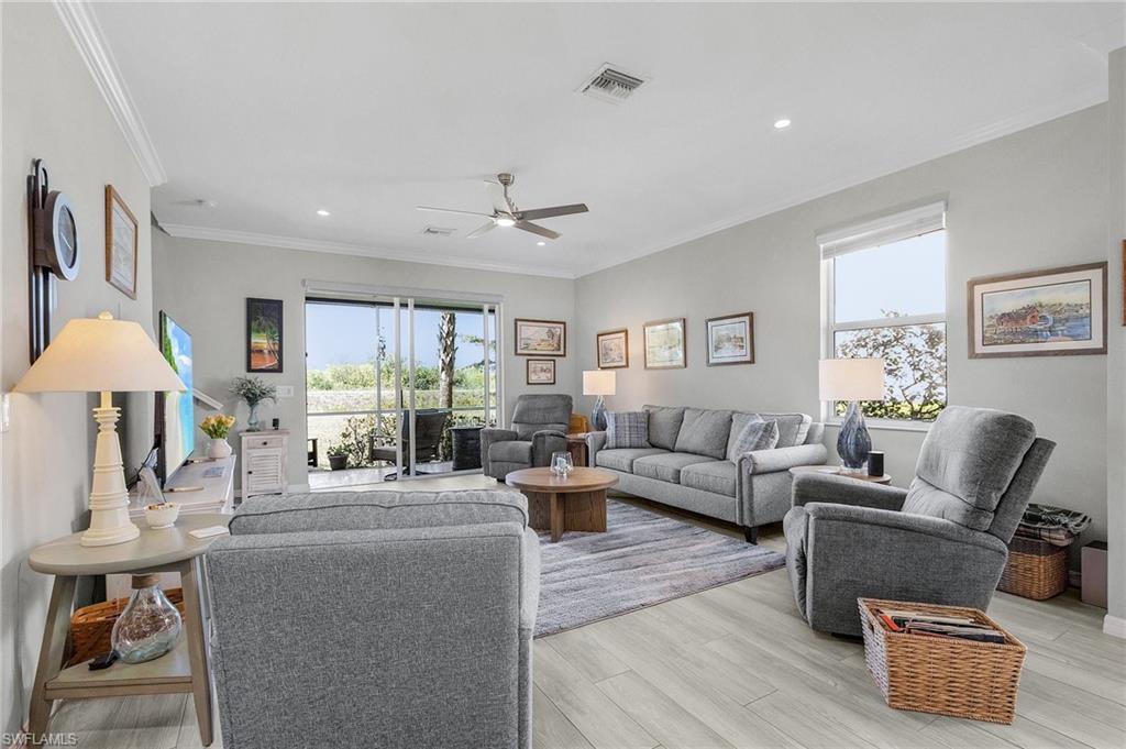 2701 Citrus Street Naples, FL 34120 - Photo 12 of 39 a living room with furniture and a chandelier