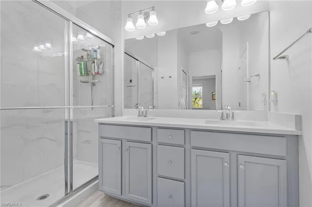 a bathroom with a sink double vanity and shower