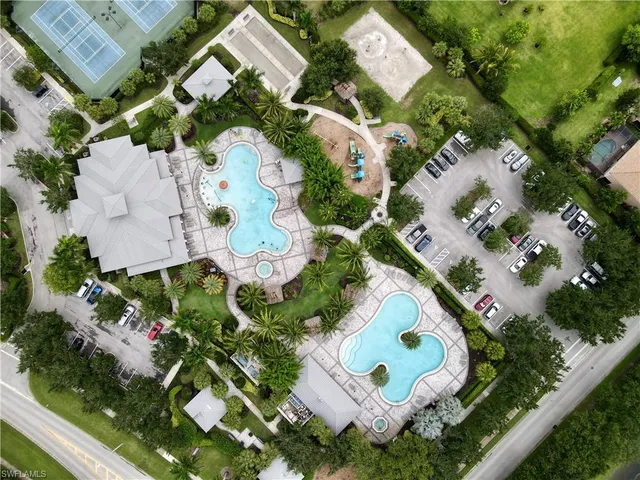 an aerial view of a house with a garden and lake view