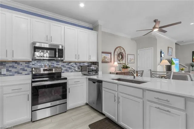 a kitchen with white cabinets and a stove