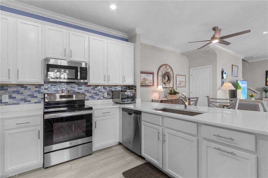 2701 Citrus Street Naples, FL 34120 - Photo 6 of 39 a kitchen with white cabinets and a stove