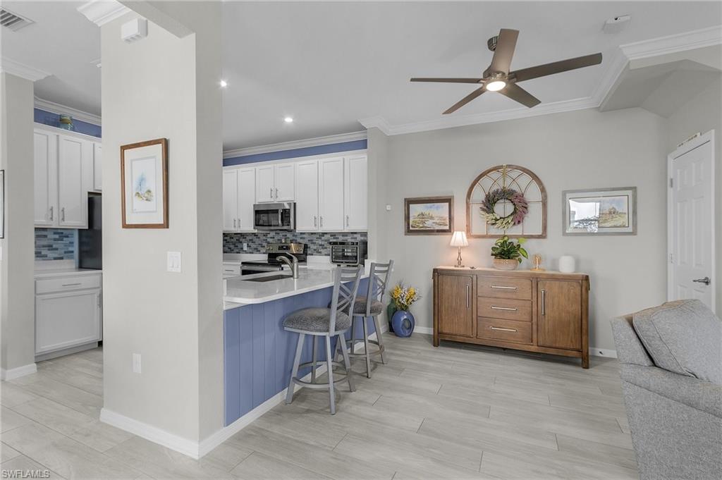 2701 Citrus Street Naples, FL 34120 - Photo 10 of 39 a kitchen with sink cabinets and window