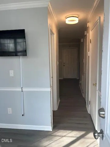 a view of a hallway with wooden floor and staircase