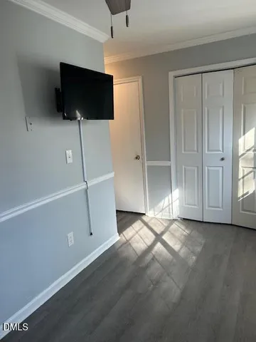 an empty room with flat screen tv