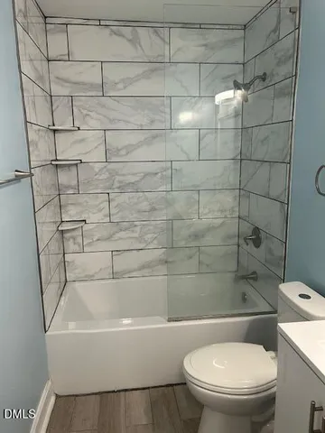 a bathroom with a toilet and shower