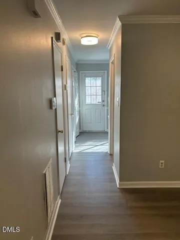 a view of a hallway with wooden floor