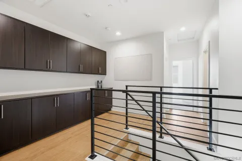 a view of a room with wooden floor