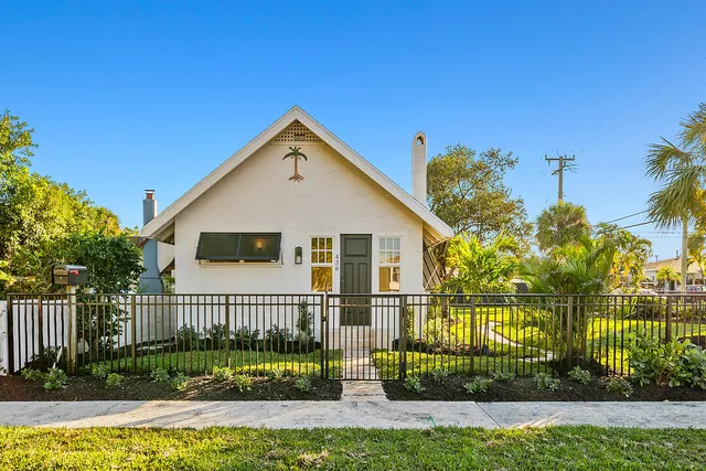 a view of a house with a small yard and plants
