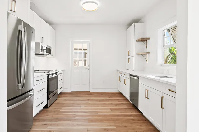 a kitchen with stainless steel appliances a stove and a refrigerator