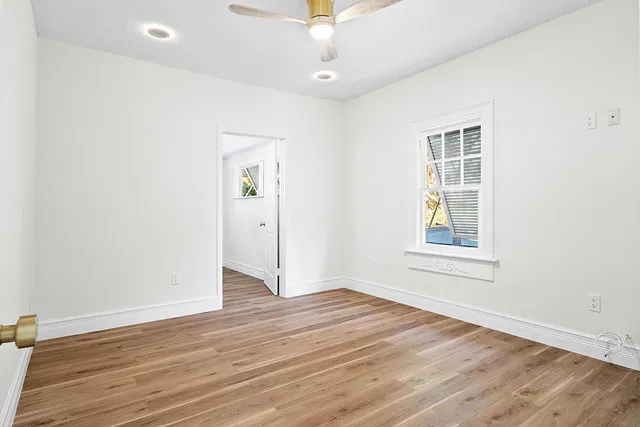 wooden floor in an empty room with a window