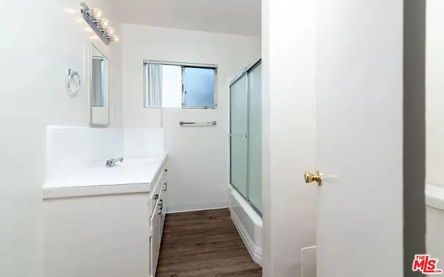 a bathroom with a sink a mirror and shower