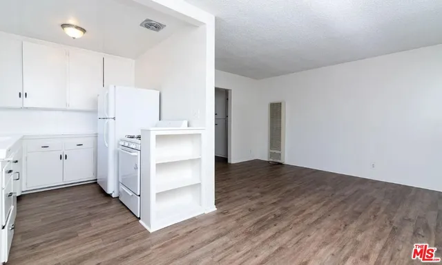 a view of a kitchen with wooden floor
