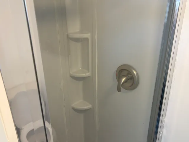 a view of a room with wooden floor and a window