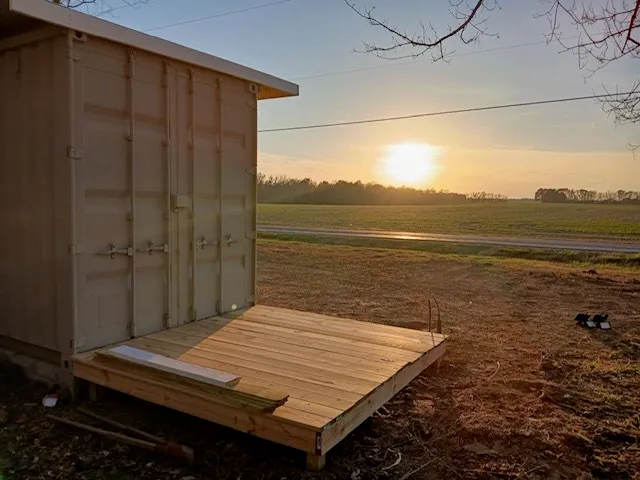 a view of a yard with wooden fence