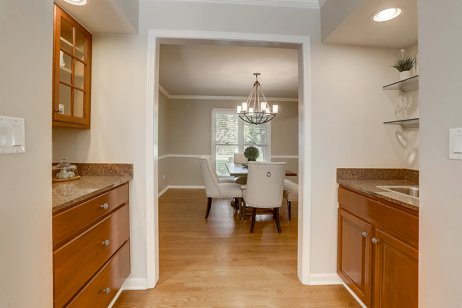 1760 Saddle Hill Road Libertyville, IL 60048 - Photo 5 of 28 a kitchen with stainless steel appliances granite countertop a stove refrigerator and a dining table with wooden floor