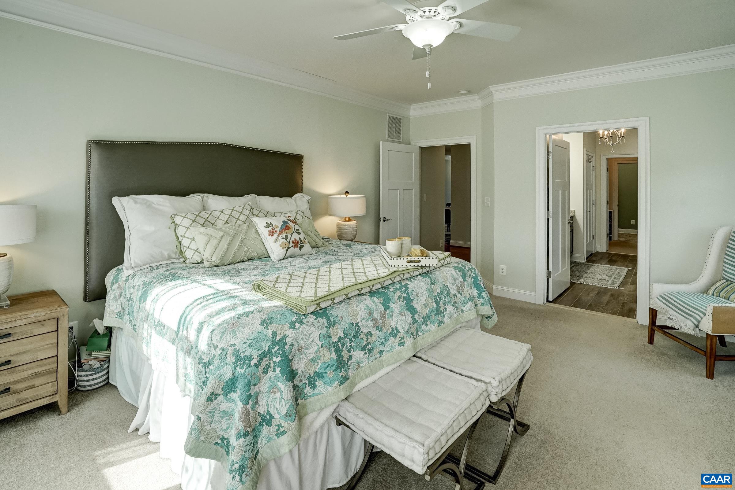 7652 Birchwood Hill Road Crozet, VA 22932 - Photo 27 of 64 a bedroom with a bed and a chandelier